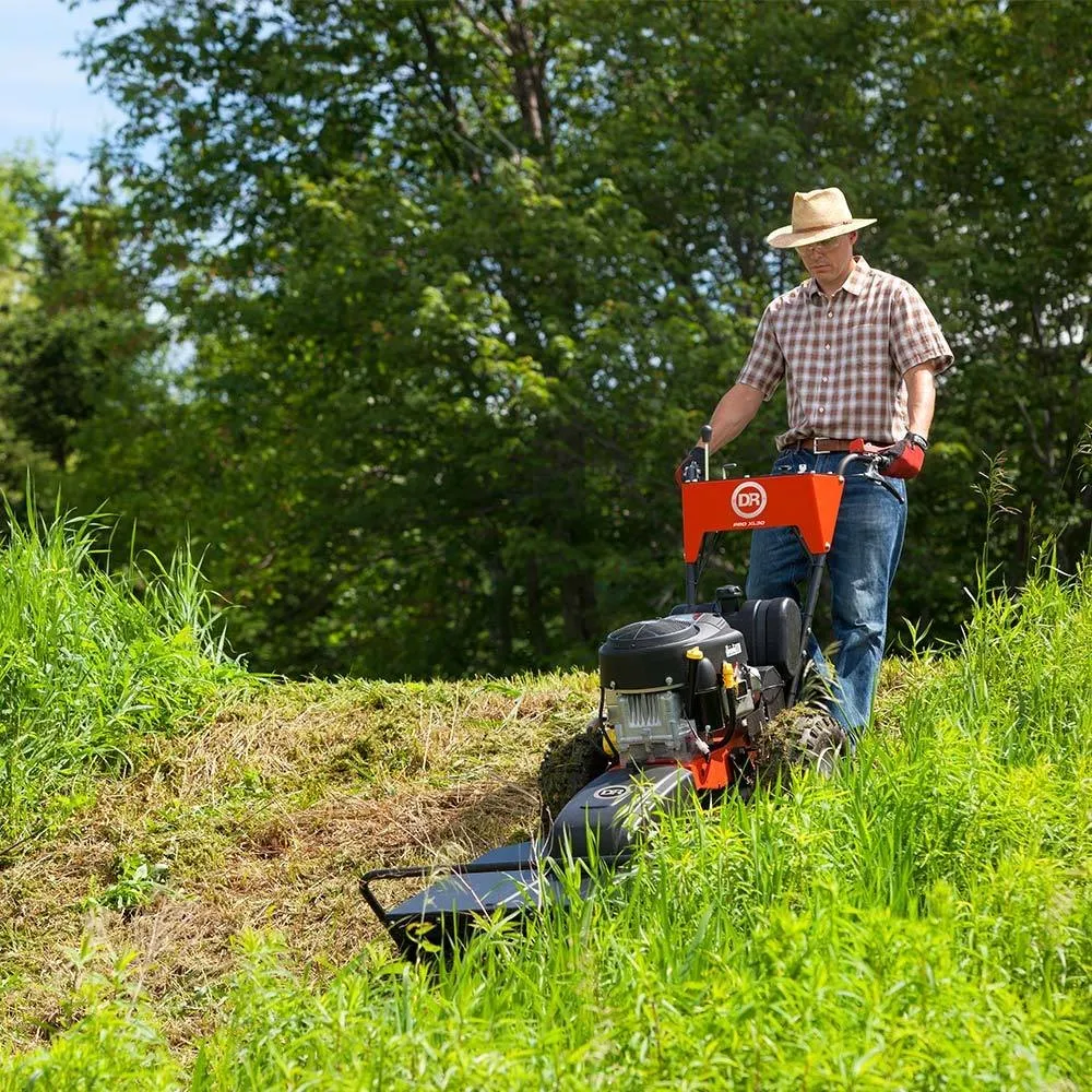 The brush mower working a steep grassy bank